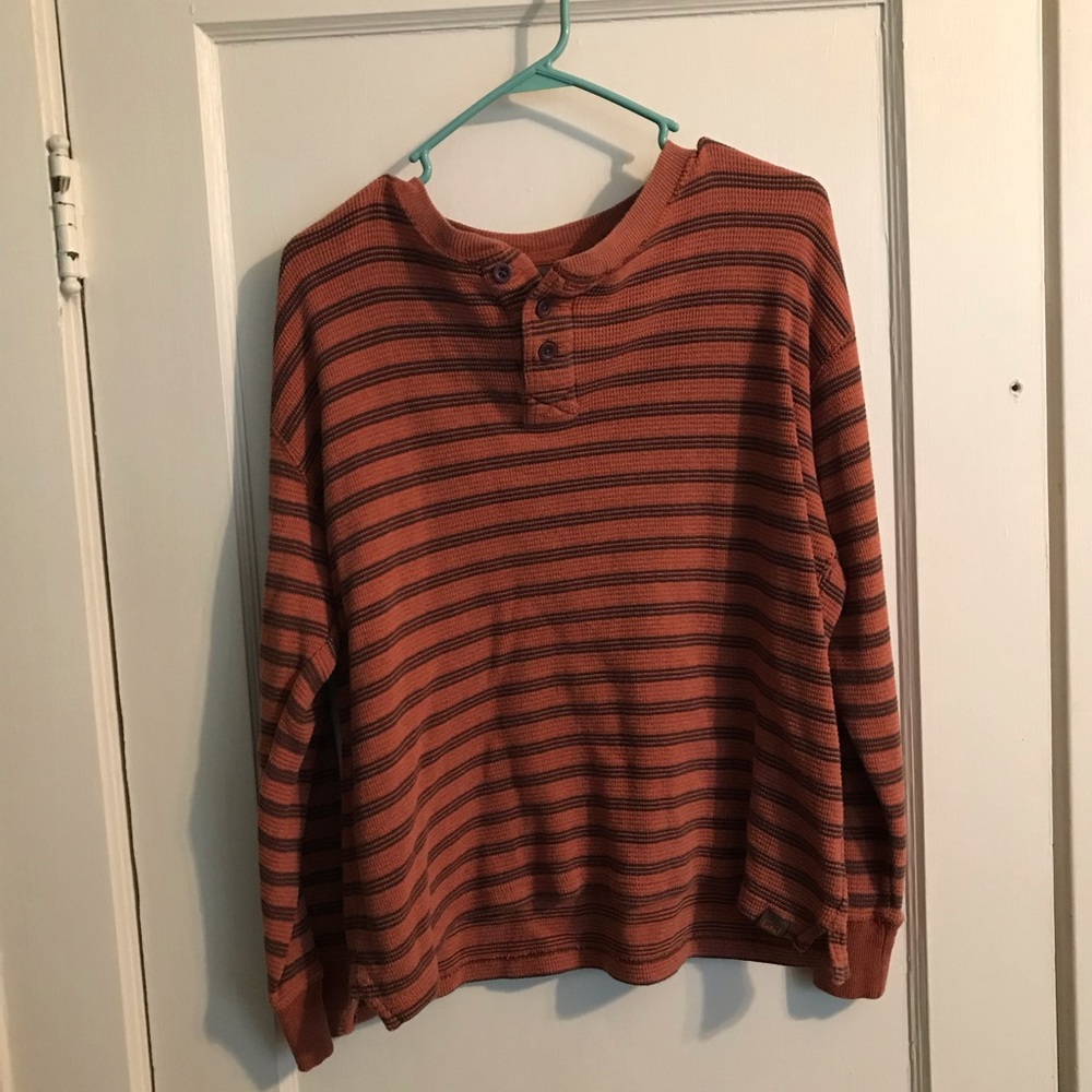 Striped orange and black shirt.
